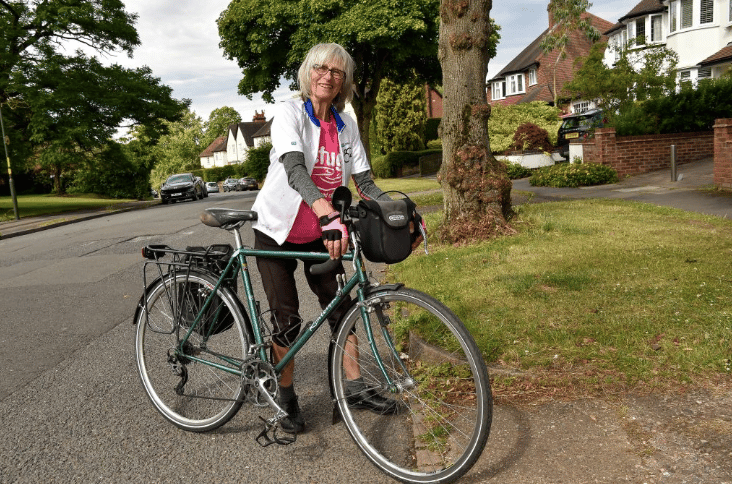 woman posing by her bike